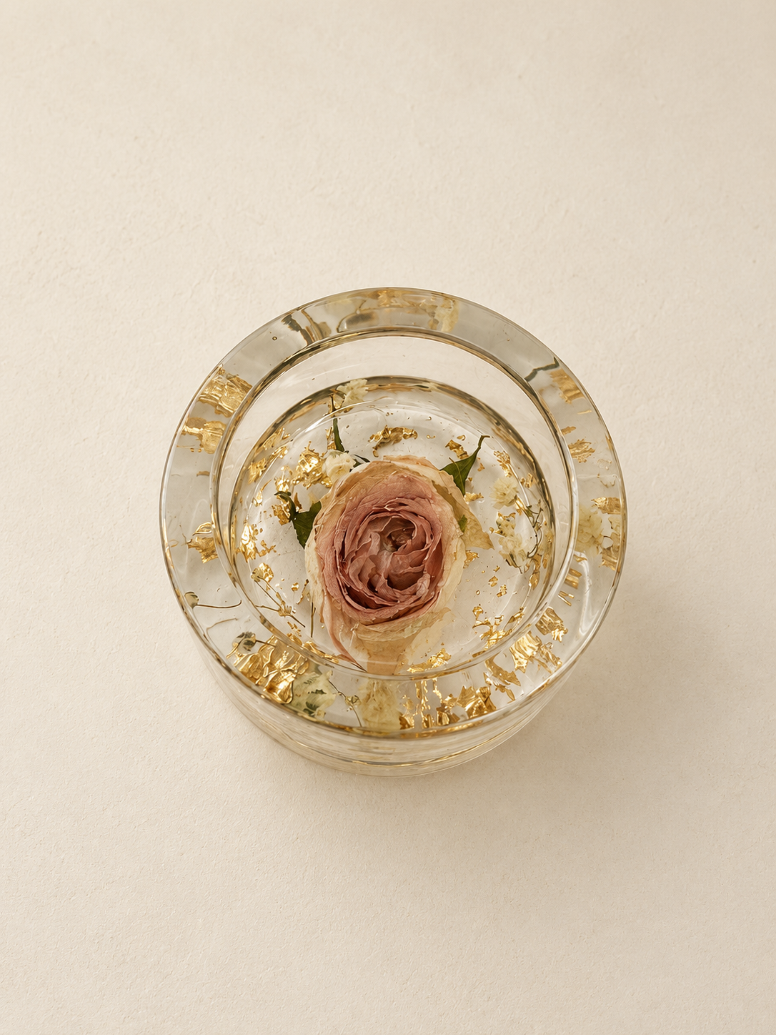 Top view of a real blush rose and delicate floral details in a clear resin candle holder, handmade in Lancashire UK by Held Forever Studio