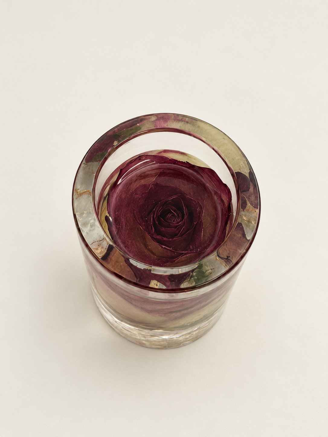 Top view of a real burgundy rose preserved in a clear resin candle holder, handmade in Lancashire UK by Held Forever Studio