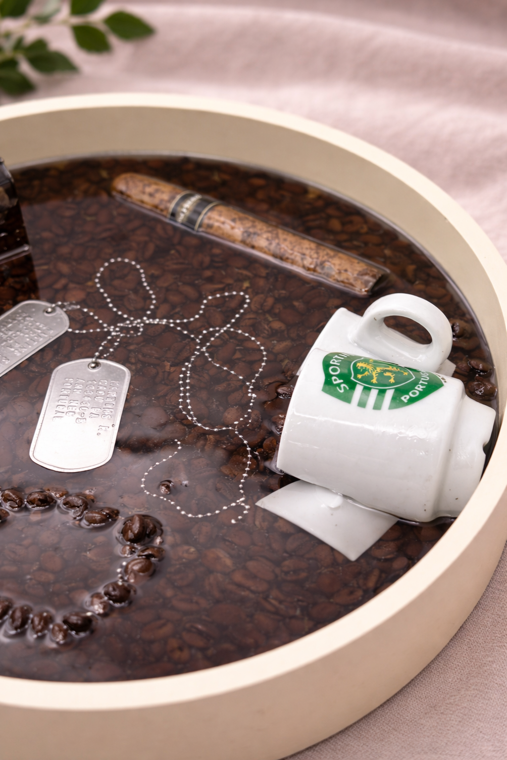 Detail of coffee beans and sentimental objects cast in dark epoxy resin, bespoke tray by Held Forever Studio