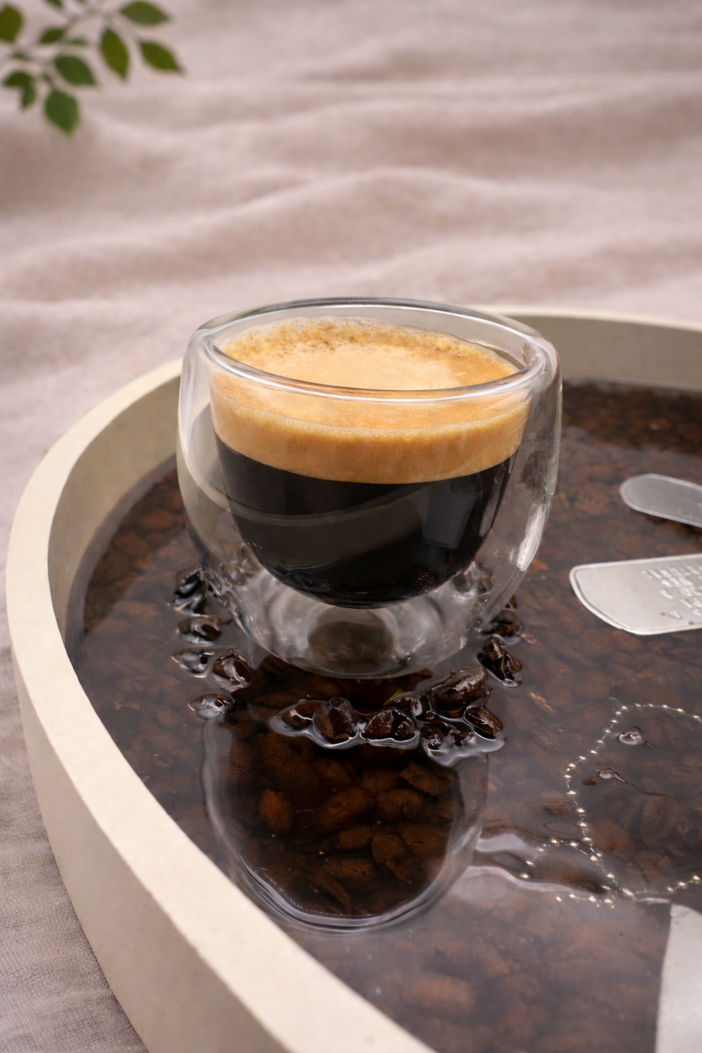 Top view of large round bespoke resin tray with keepsakes in dark glossy resin, handmade by Held Forever Studio