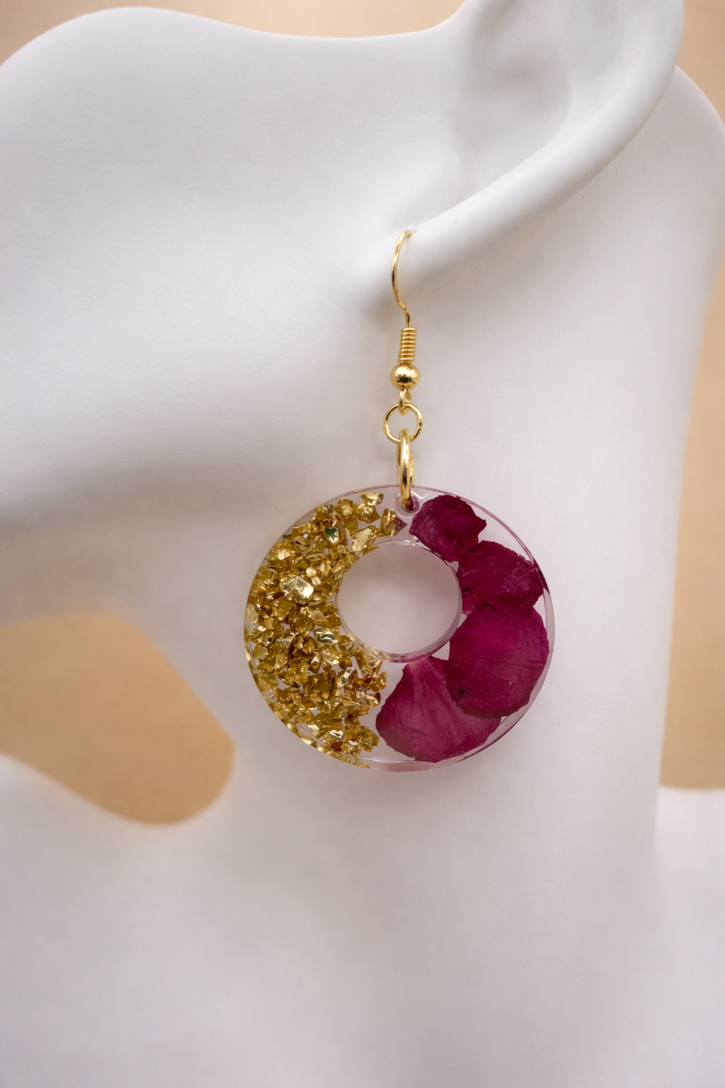 Pair of rose petal and gold foil resin hoop earrings on acrylic stand — handmade in Lancashire UK by Held Forever Studio