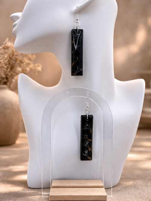 Black resin bar earrings with real dandelion seeds and dried botanicals on display stand, handmade by Held Forever Studio in Lancashire UK