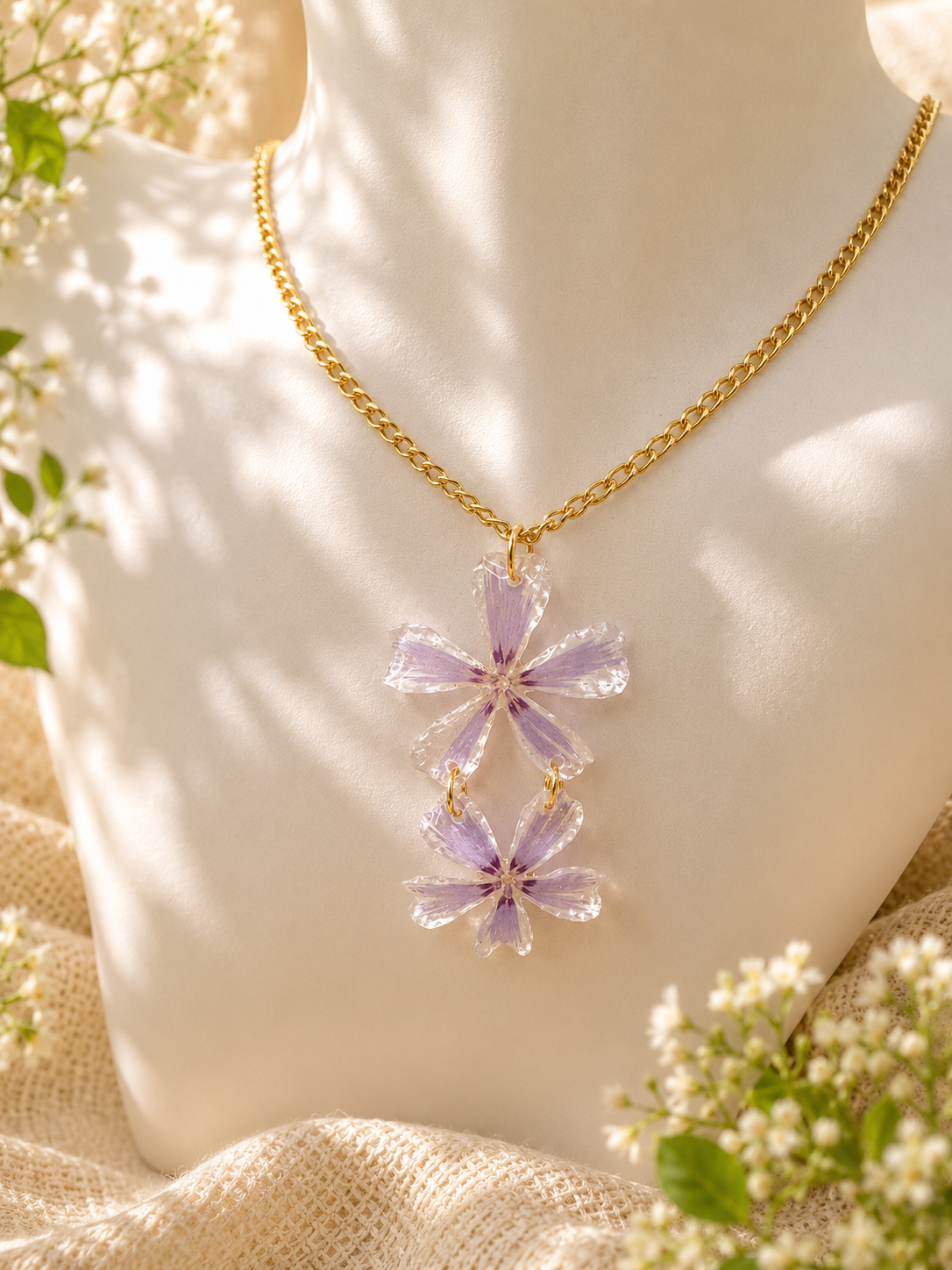 Close up of lilac pressed flower stud earring showing gold plated post and real flower detail, handmade by Held Forever Studio