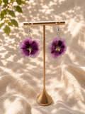 Pair of pressed flower resin disc earrings on a stand, whole purple flower in resin with 925 sterling silver hooks, handmade by Held Forever Studio