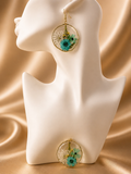 Round resin drop earring with real pressed teal chrysanthemum and gypsophila set in gold wire frame, handmade by Held Forever Studio
