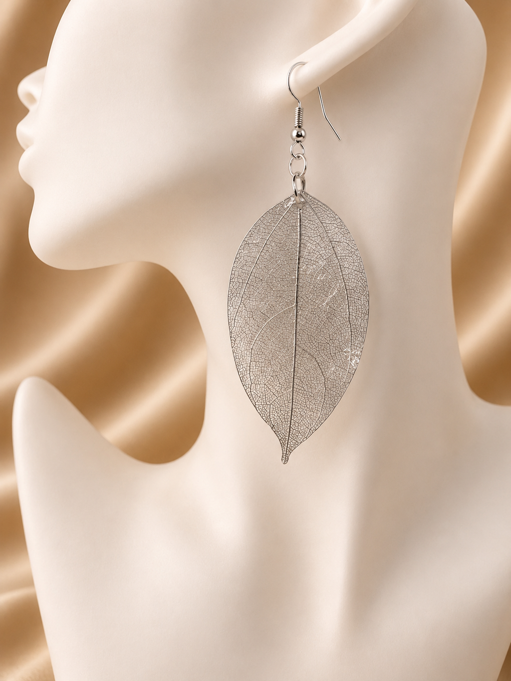 Real skeleton leaf drop earring in silver on jewellery mannequin, handmade by Held Forever Studio