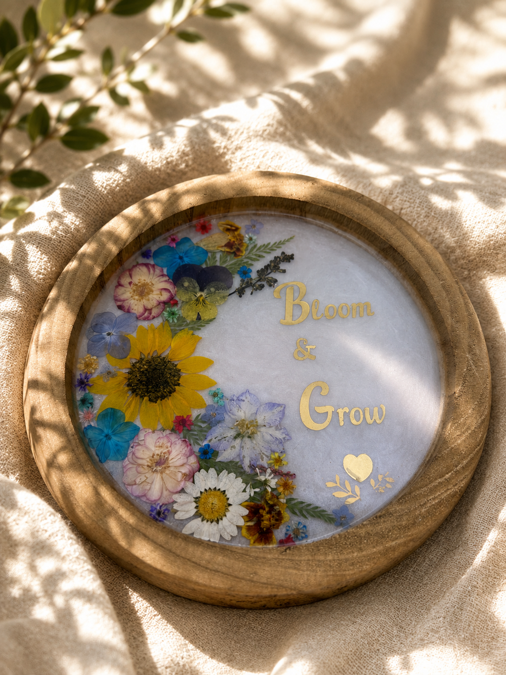 Close up of pressed flower resin tray with sunflowers, daisies and pansies, handmade in Lancashire UK