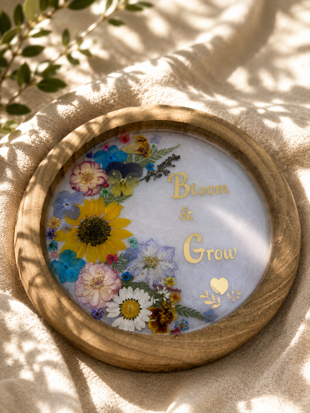 Close up of pressed flower resin tray with sunflowers, daisies and pansies, handmade in Lancashire UK