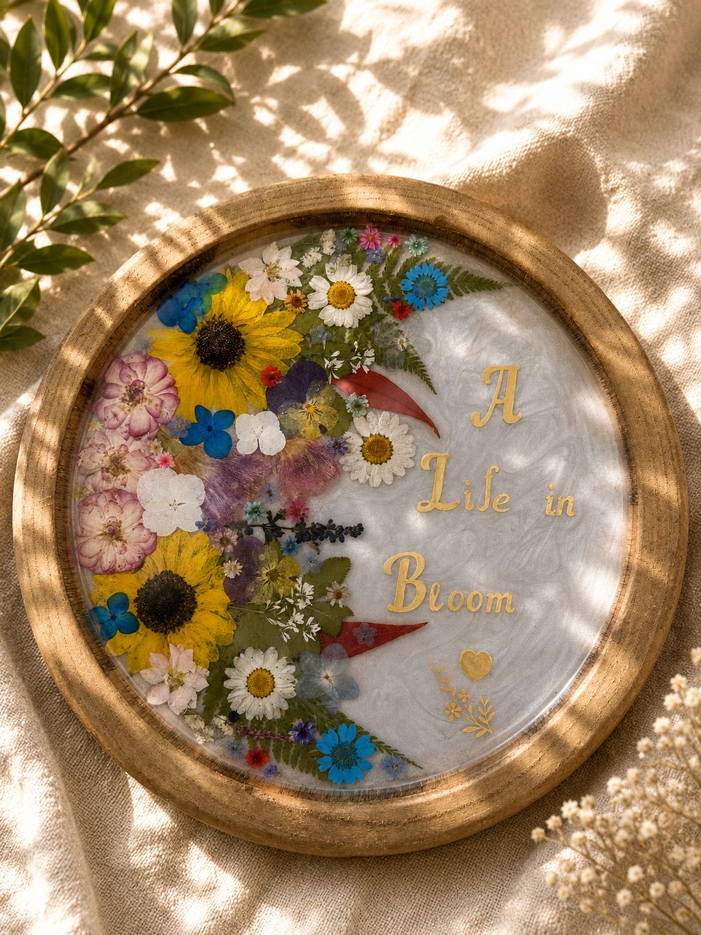 Pressed flower resin tray in wood frame reading A Life in Bloom with gold foil lettering, handmade in Lancashire UK