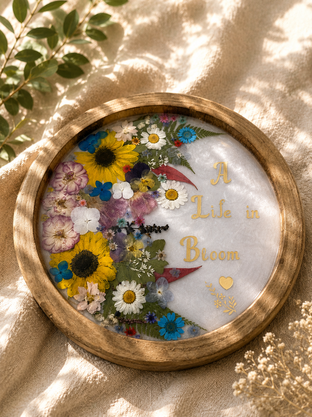 Close up of pressed flower resin tray with real dried flowers and ferns, handmade by Held Forever Studio