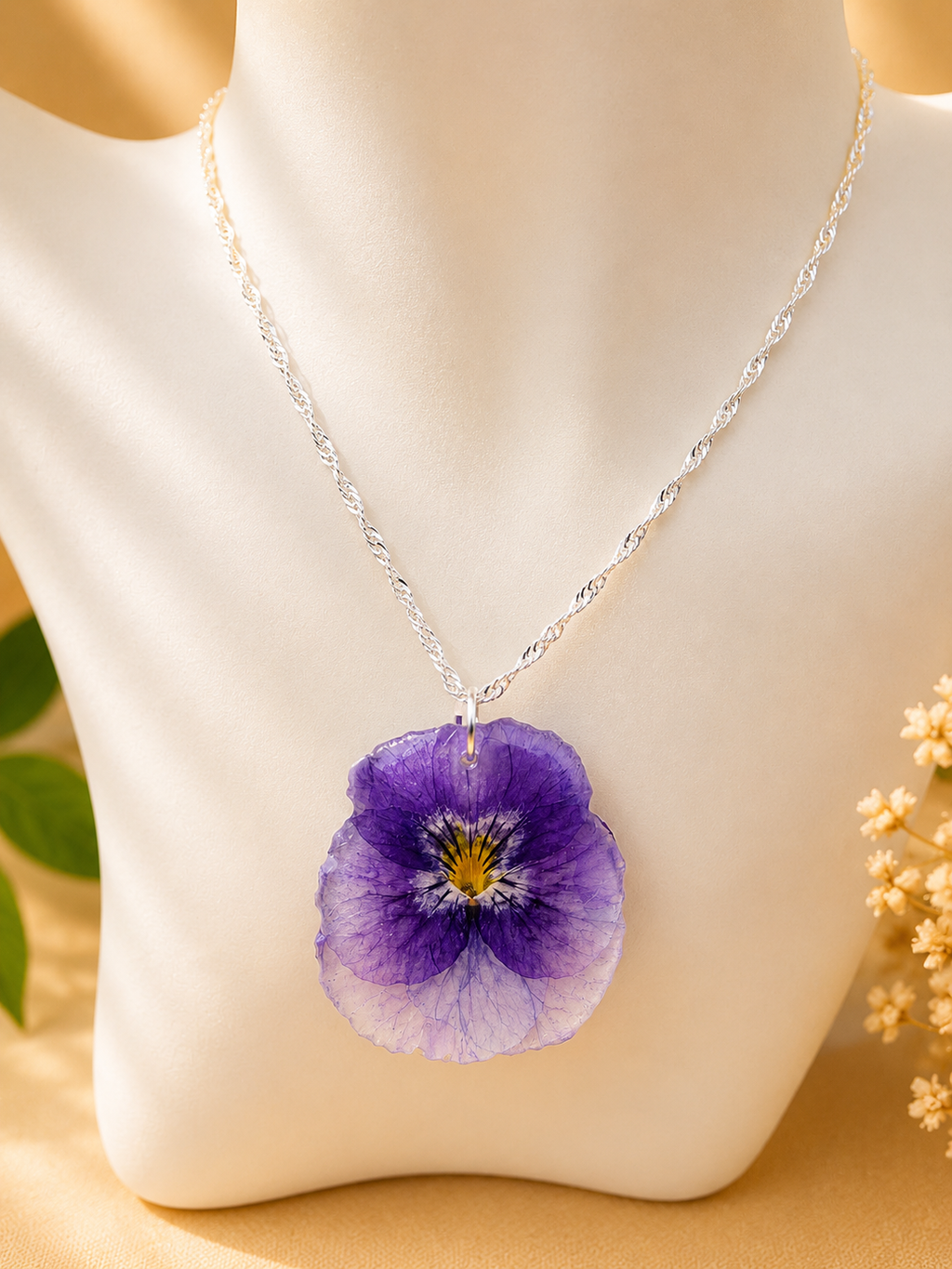 Pansy pressed flower jewellery set styled together on a stand, earrings and necklace in 925 sterling silver, handmade by Held Forever Studio