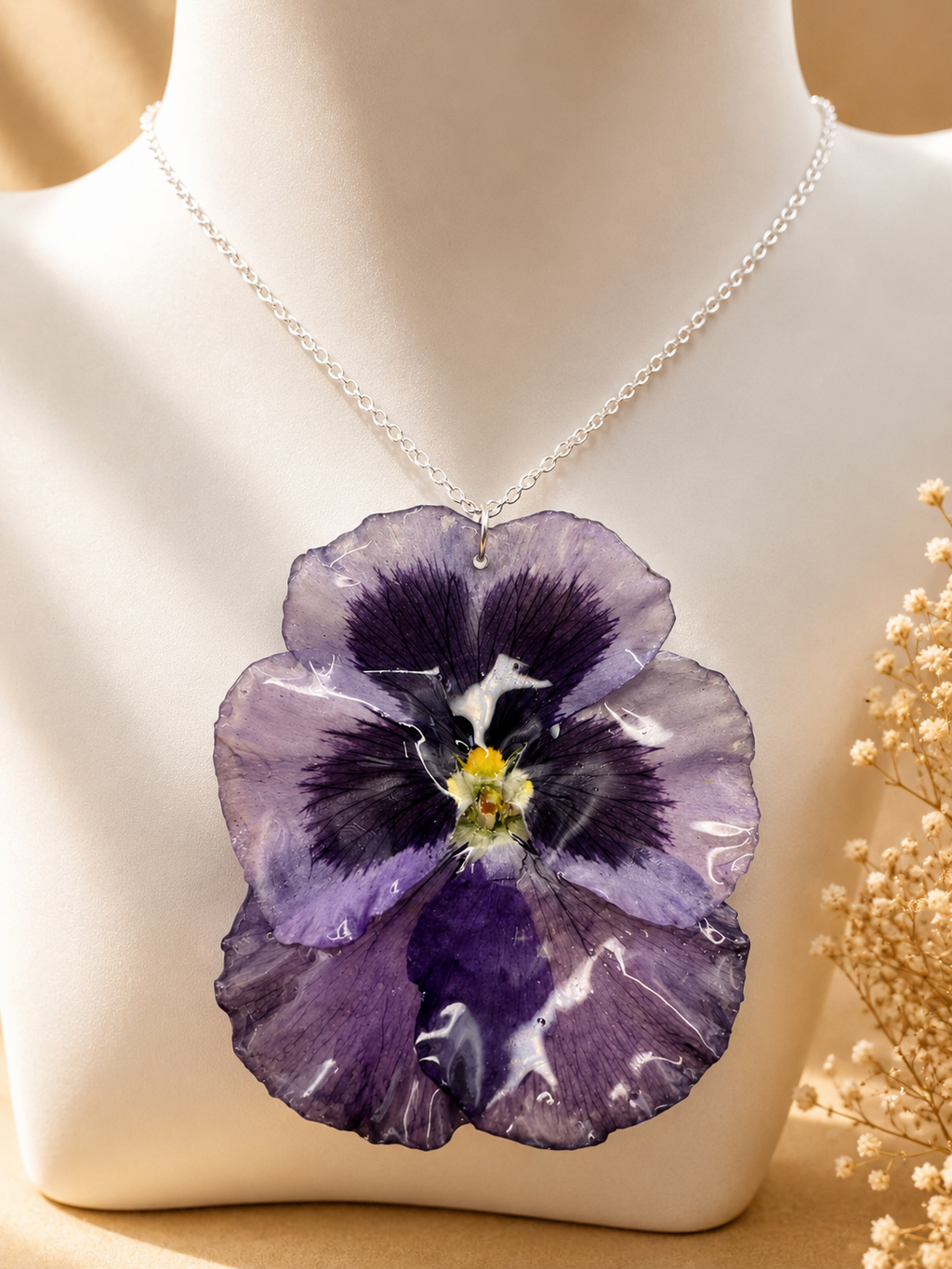 Close up of deep purple pansy pressed flower pendant necklace showing real flower detail and 925 sterling silver chain, handmade in Lancashire UK