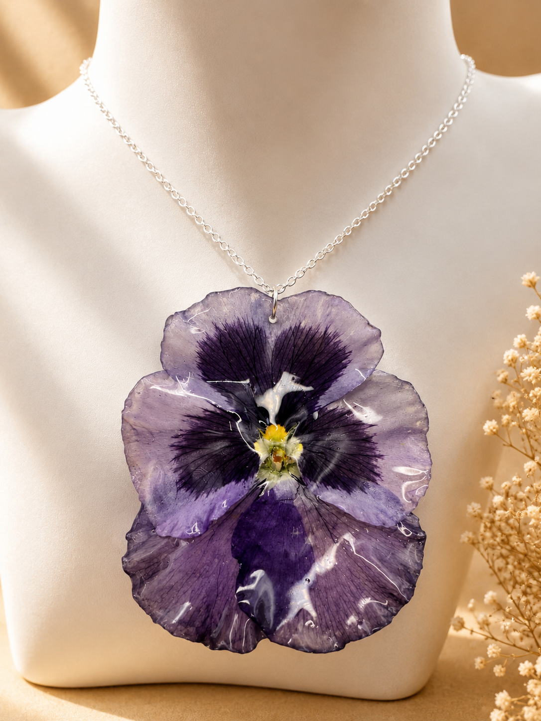 Close up of deep purple pansy pressed flower pendant necklace showing real flower detail and 925 sterling silver chain, handmade in Lancashire UK