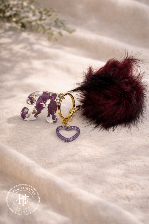 Handmade resin initial keyring with real dried flowers, gold hardware and faux fur pom pom by Held Forever Studio