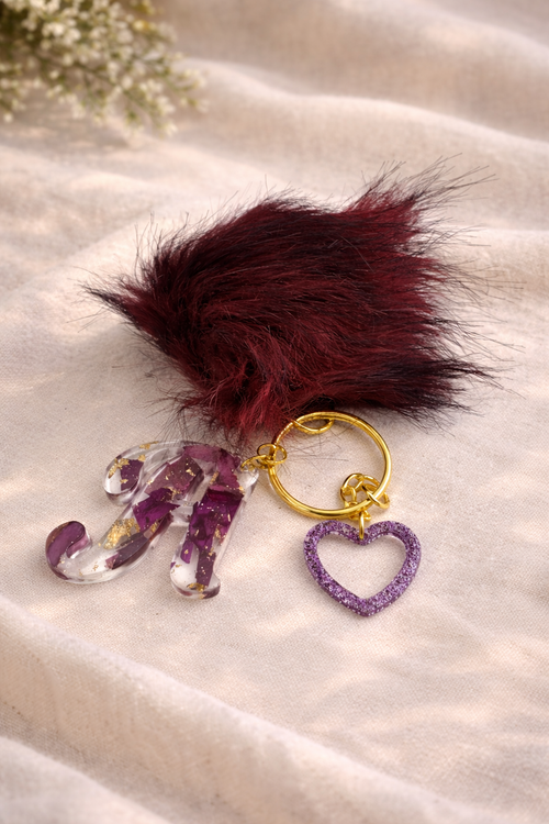 Personalised resin initial letter keyring with real dried flower petals, gold leaf flakes and heart charm by Held Forever Studio