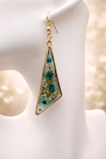Blue pressed flower resin drop earrings in gold-tone triangle frames with forget-me-nots, cornflower and gypsophila, handmade by Held Forever Studio in Lancashire UK
