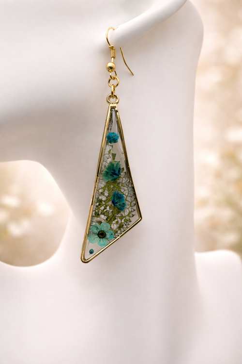 Blue pressed flower resin drop earrings in gold-tone triangle frames with forget-me-nots, cornflower and gypsophila, handmade by Held Forever Studio in Lancashire UK