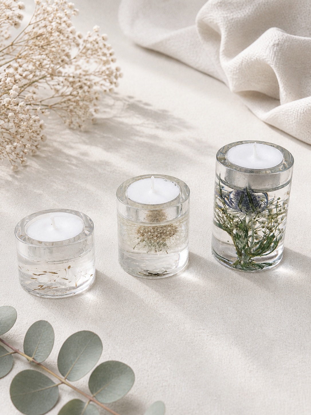 Close up of medium resin tealight holder with whole dandelion clock preserved in clear resin, handmade by Held Forever Studio