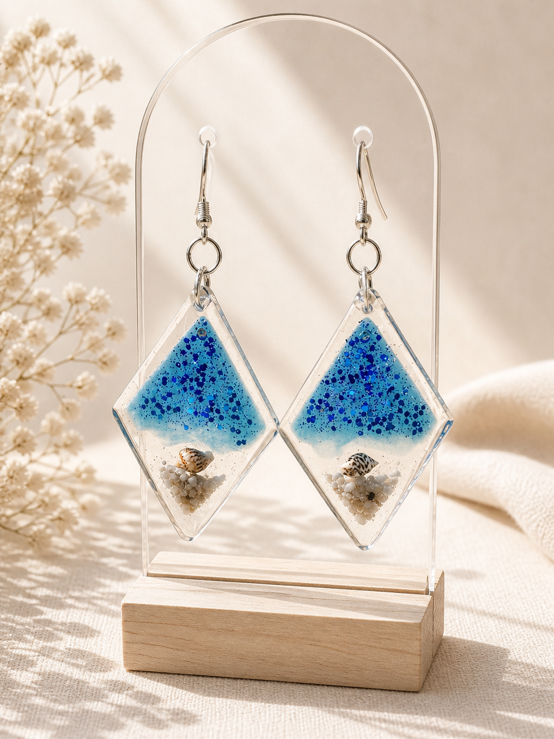 Ocean beach resin drop earrings on mannequin with Held Forever Studio branded card, handmade jewellery Lancashire UK
