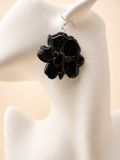 Black and gold resin flower drop earring on mannequin, handmade by Held Forever Studio in Lancashire UK