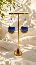 Ocean wave resin drop earrings in an open wire teardrop frame with sand-textured base and silver shell charm, on 925 sterling silver hooks, handmade by Held Forever Studio