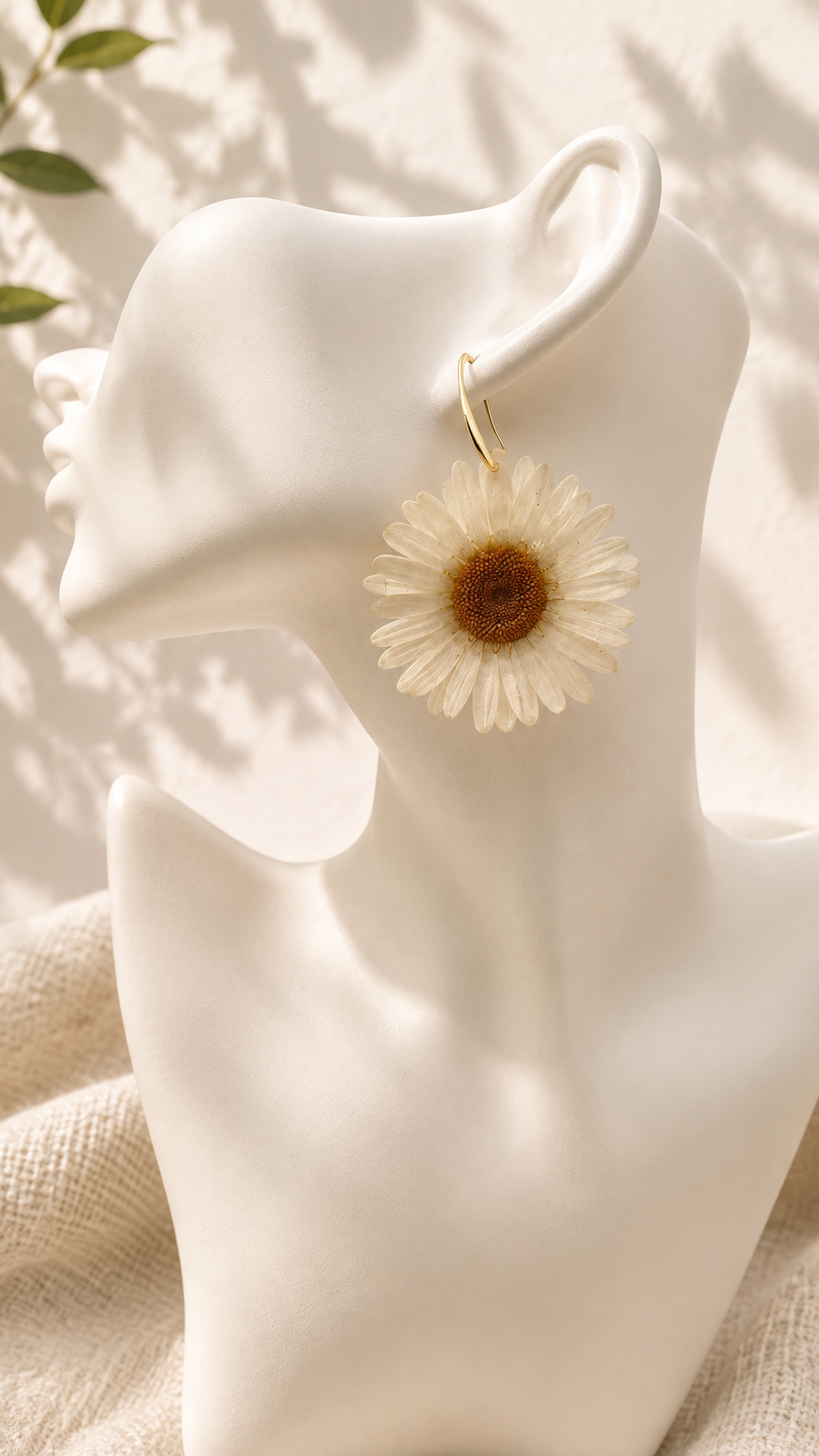 Close-up of real pressed daisy flower preserved in clear resin drop earring
