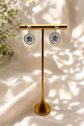 Pressed forget-me-not resin disc earring worn, twisted 925 sterling silver bezel and ball stud