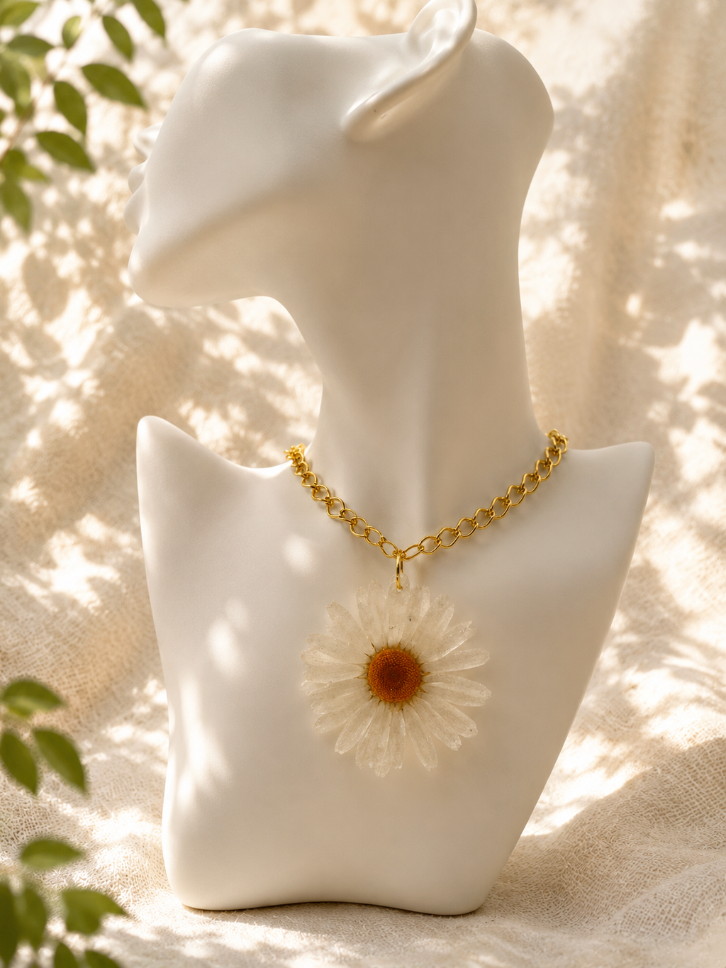 Close up of white daisy resin pendant necklace on a mannequin bust, handmade in Lancashire UK