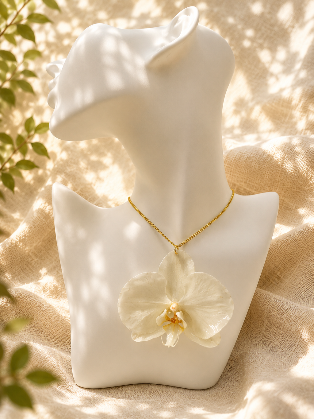 White orchid resin pendant necklace on a gold-plated chain, handmade by Held Forever Studio