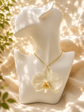 White orchid resin pendant necklace on a gold-plated chain, handmade by Held Forever Studio