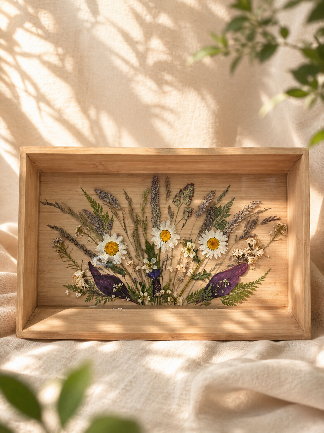 Pressed wildflower and daisy resin tray in a bamboo frame, handmade by Held Forever Studio