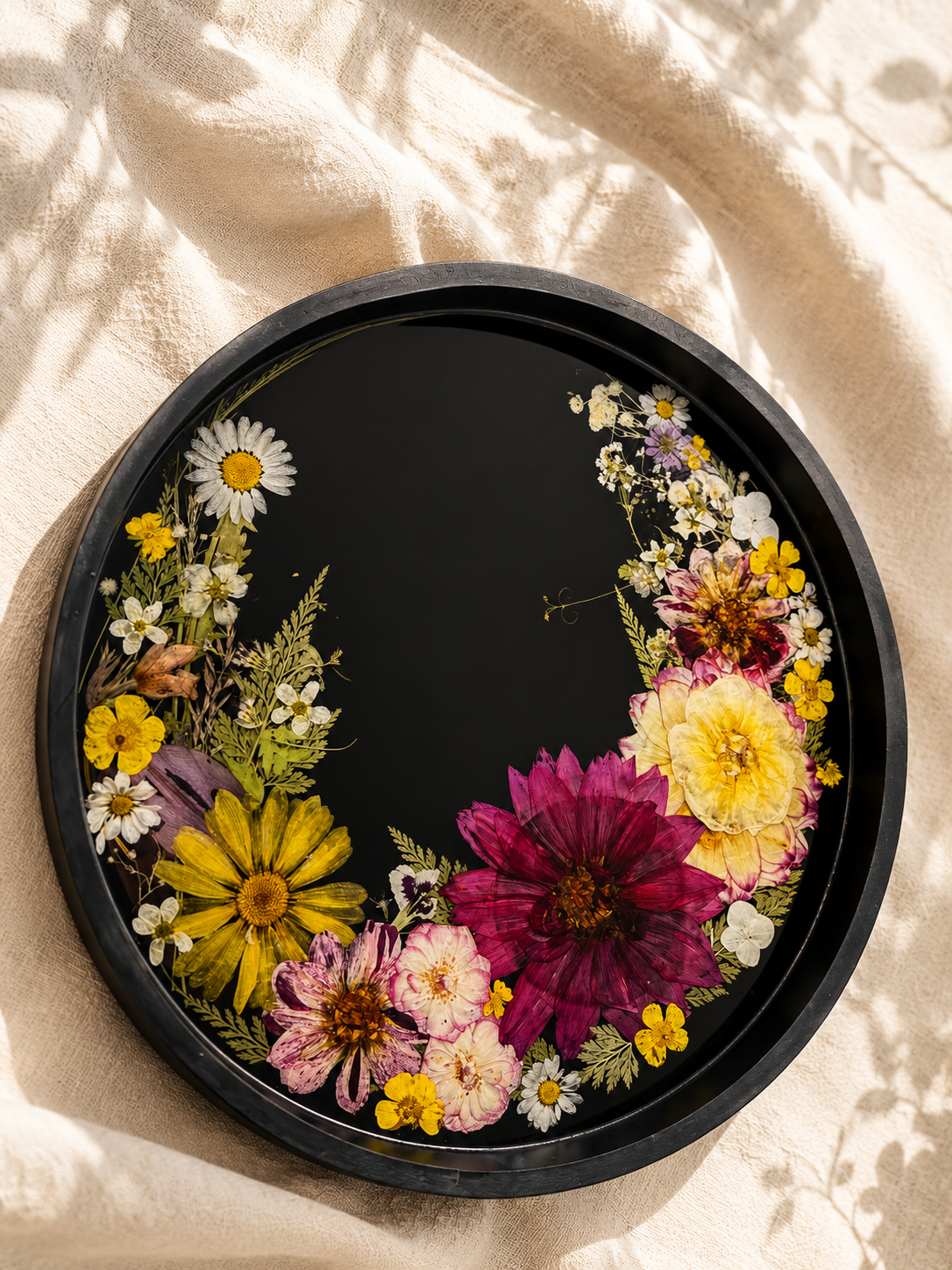 Close up of the black resin tray showing pressed dahlias and daisies, handmade in Lancashire UK