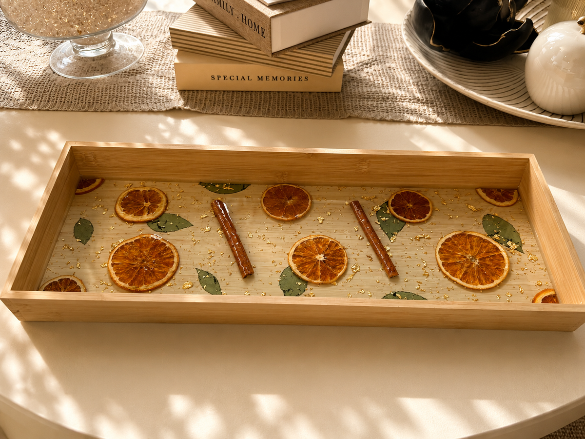 Long citrus resin serving tray in a bamboo frame with real dried orange slices and cinnamon sticks, handmade by Held Forever Studio