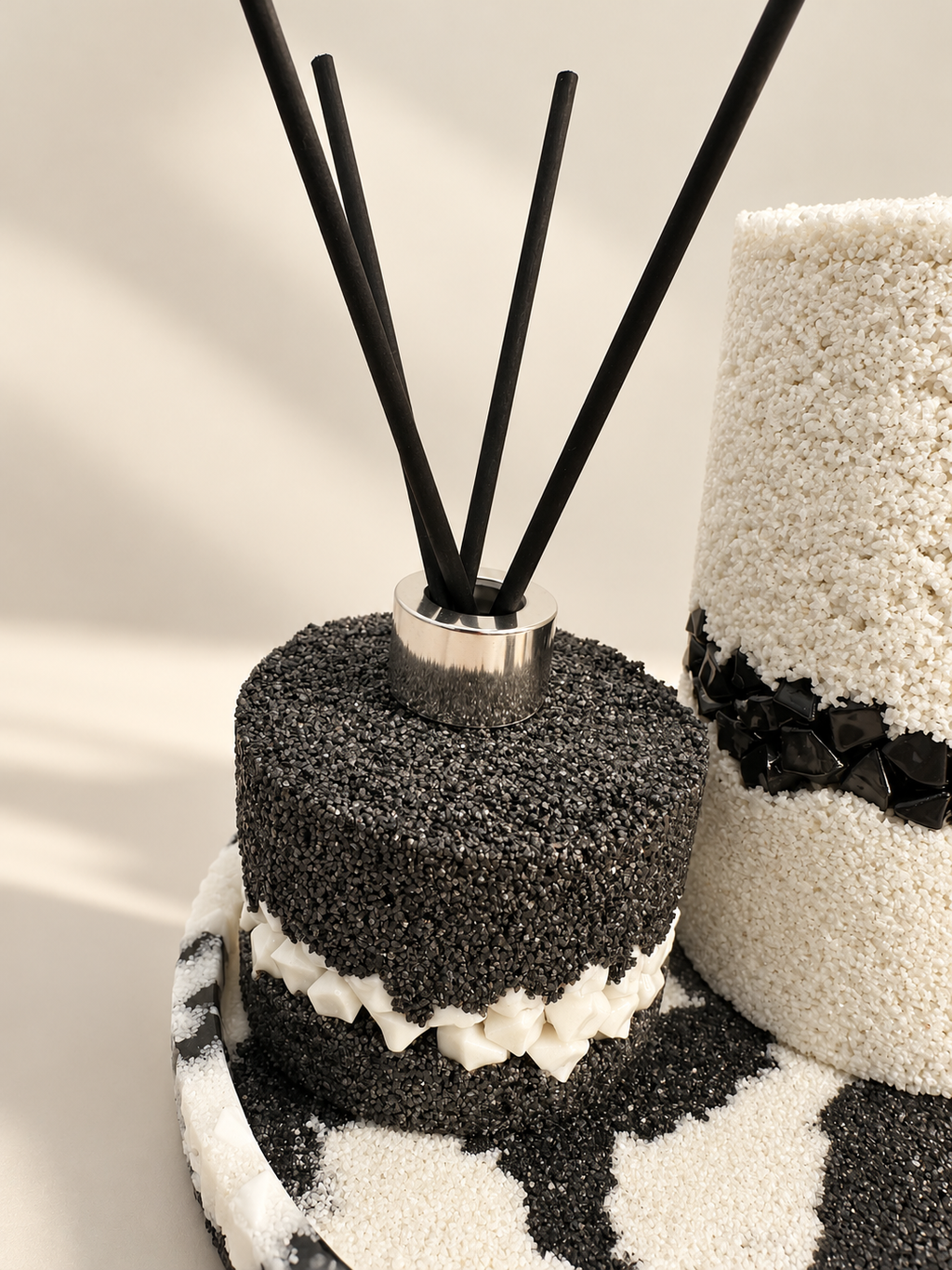 Black sand-textured diffuser bottle with a white stone band and silver-coloured collar, hand-decorated in Lancashire UK by Held Forever Studio; reeds not included