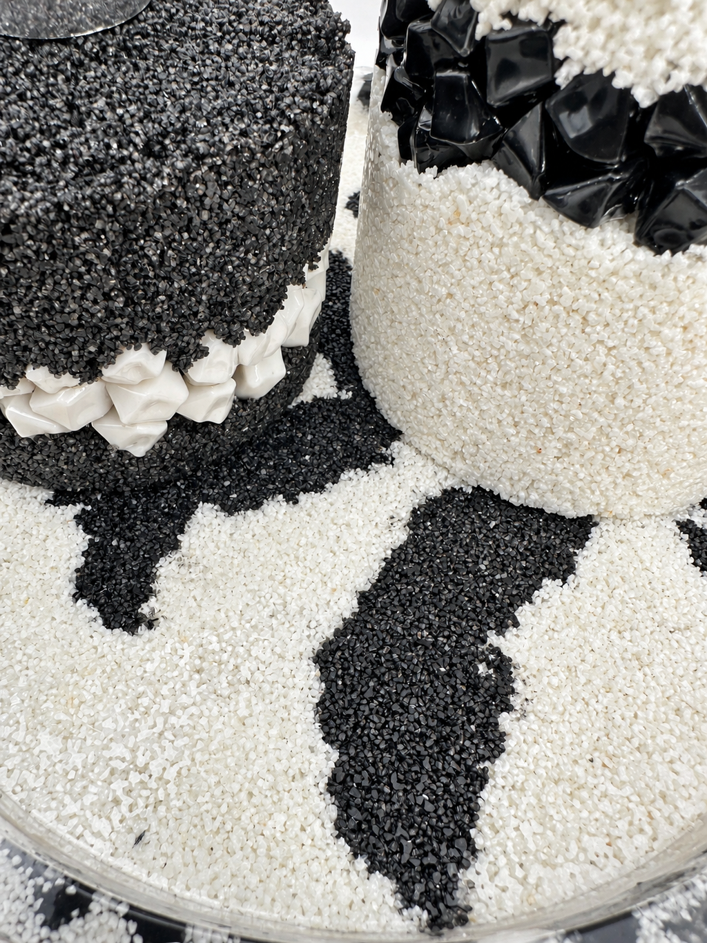 Detail of a black-and-white patterned resin tray with sand texture and stone edging, handmade in Lancashire UK by Held Forever Studio