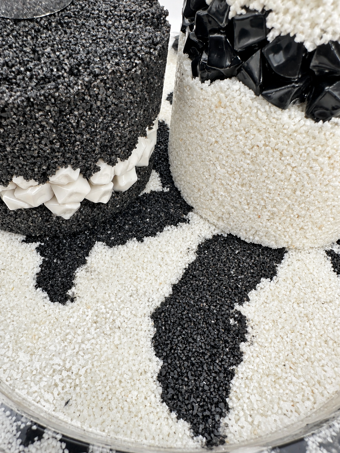 Detail of a black-and-white patterned resin tray with sand texture and stone edging, handmade in Lancashire UK by Held Forever Studio