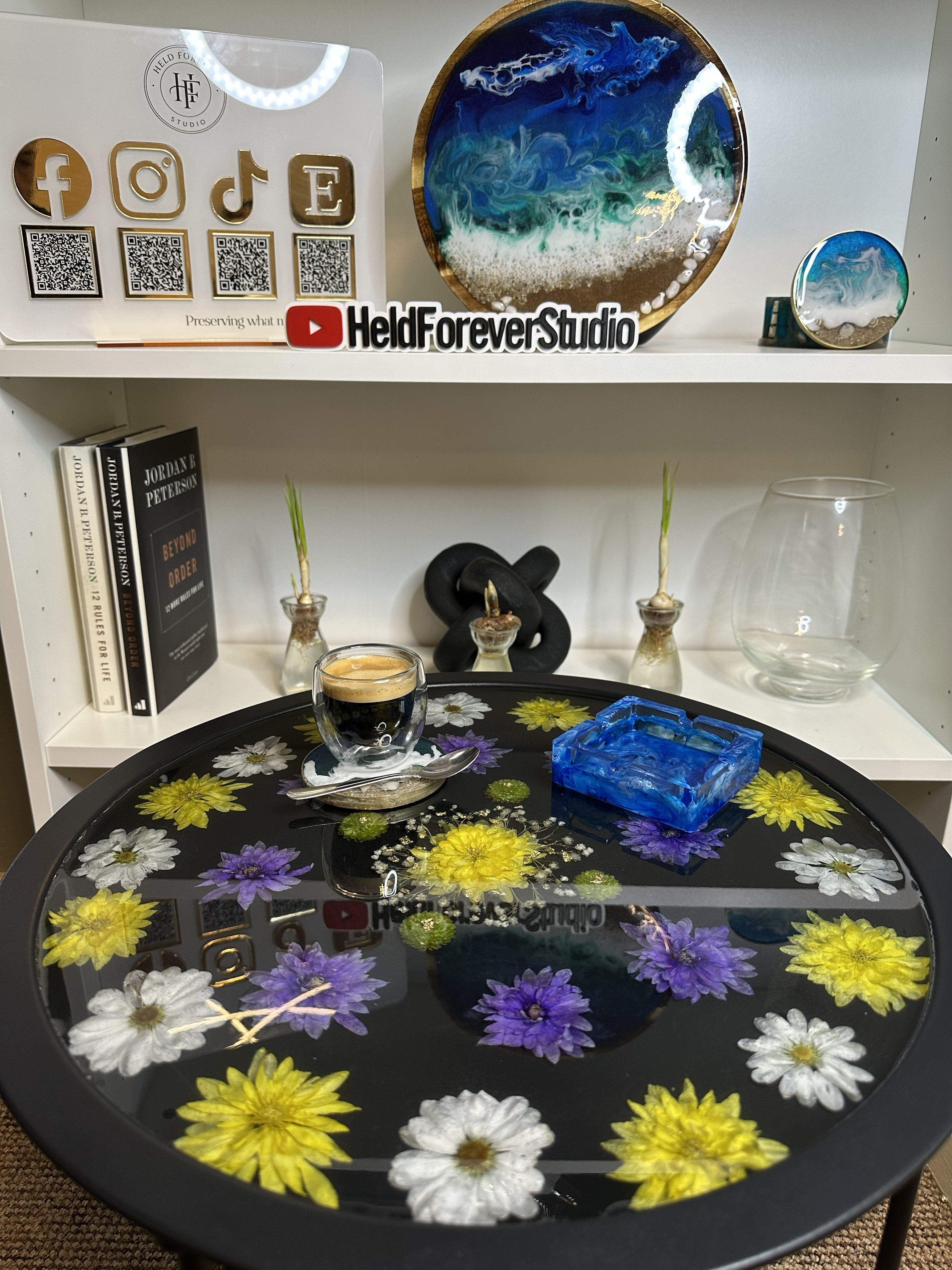 Close up of real pressed flowers set in resin tray table, handmade by Held Forever Studio