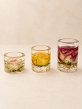 Set of three clear resin candle holders with real blush, yellow and burgundy roses and gold-coloured details, handmade in Lancashire UK by Held Forever Studio